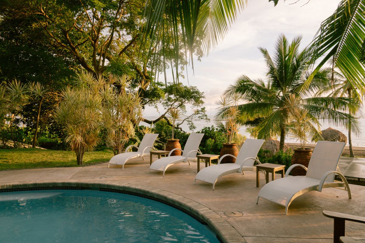 Poolside lounge chairs at Sansara Resort