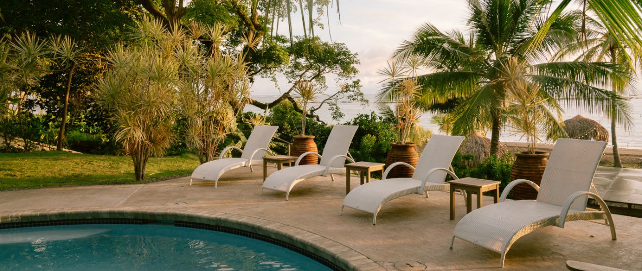Poolside lounge chairs at Sansara Resort