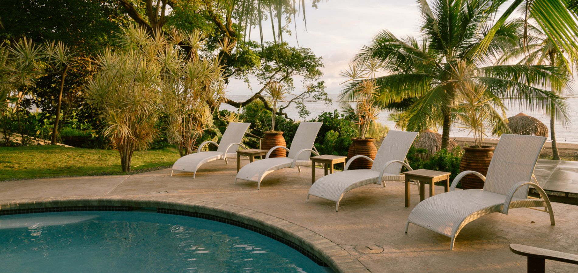 Poolside lounge chairs at Sansara Resort