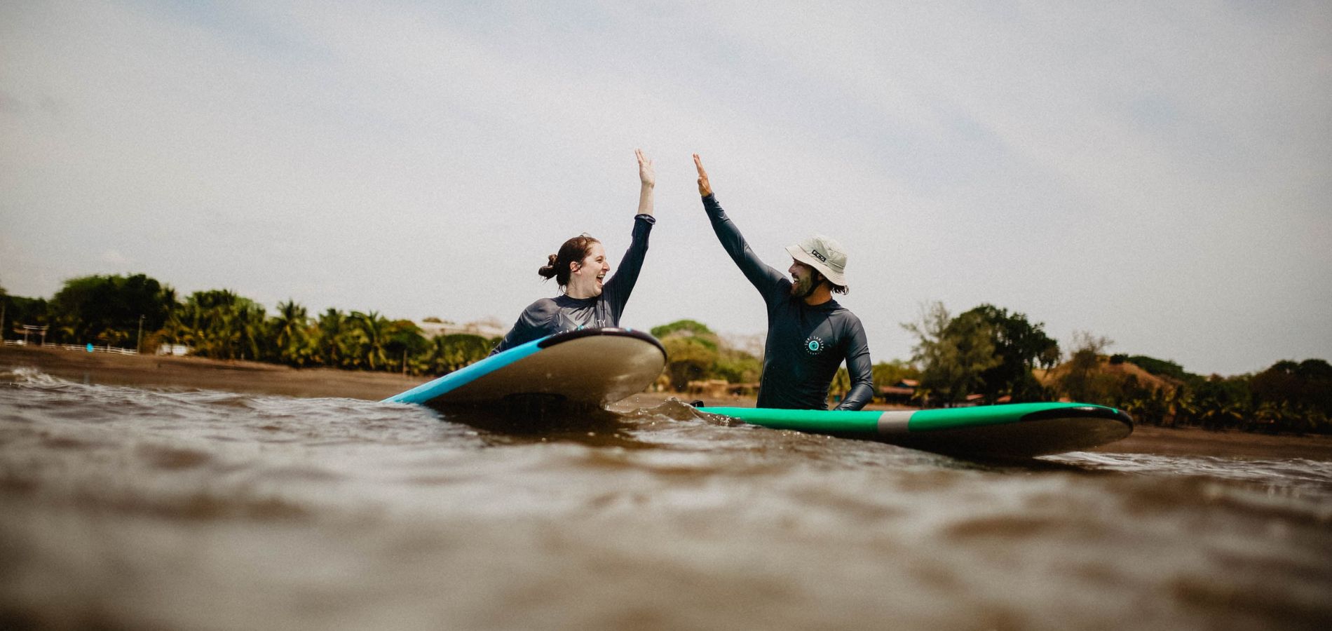 Couple surf high five